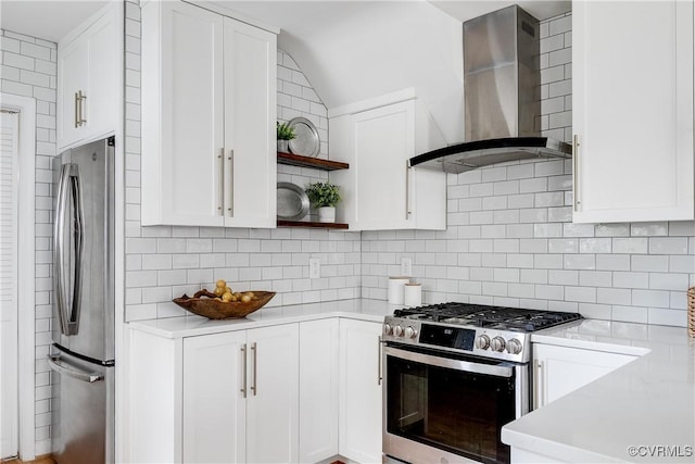 kitchen with wall chimney range hood, stainless steel appliances, light countertops, and open shelves