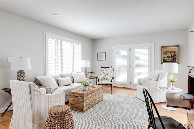 living area with plenty of natural light and light wood finished floors
