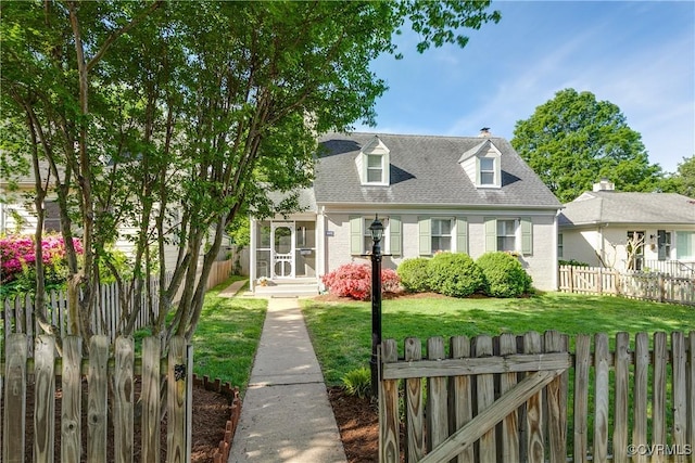 cape cod house with a chimney, brick siding, fence private yard, a shingled roof, and a front lawn