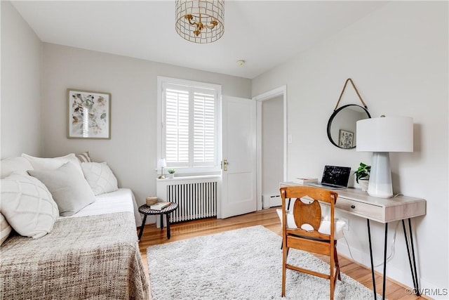interior space with baseboard heating, radiator heating unit, and wood finished floors