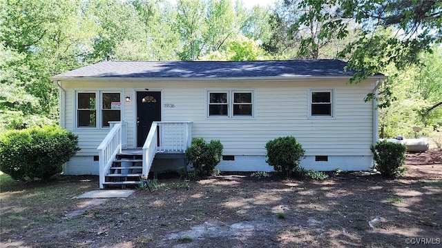 view of front of home with roof with shingles and crawl space