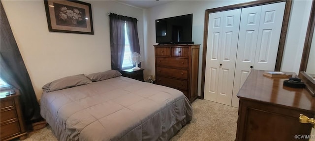 bedroom with light colored carpet and a closet