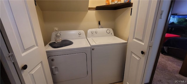 clothes washing area featuring separate washer and dryer, carpet flooring, and laundry area