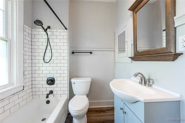 bathroom featuring vanity, shower / bathing tub combination, toilet, baseboards, and wood finished floors