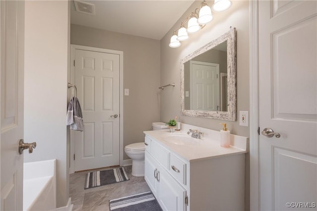 bathroom featuring a tub, visible vents, toilet, and vanity