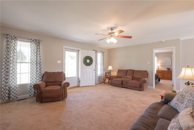 carpeted living room featuring ceiling fan