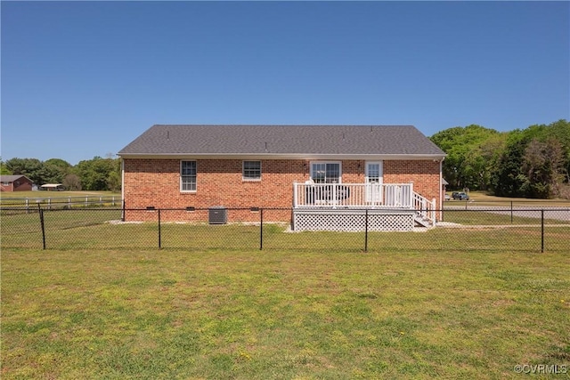 back of property with a lawn, a fenced backyard, and brick siding