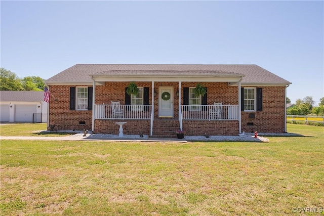 ranch-style home with covered porch, a front yard, and brick siding