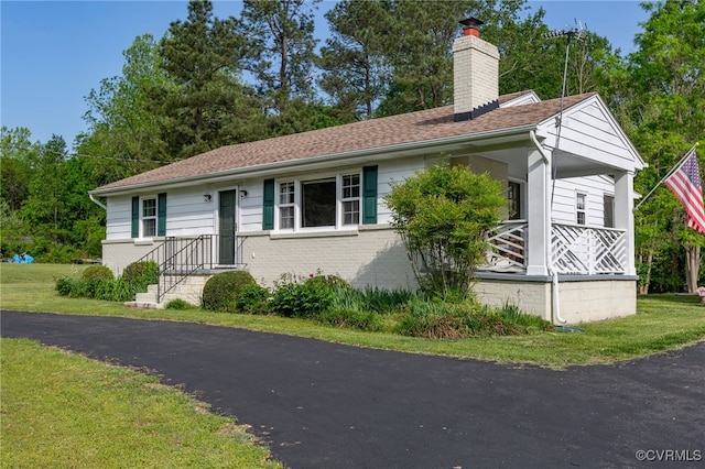 149 Courthouse Ln, Bowling Green, VA 22427 - ranch-style home with a chimney, brick siding, and a front lawn