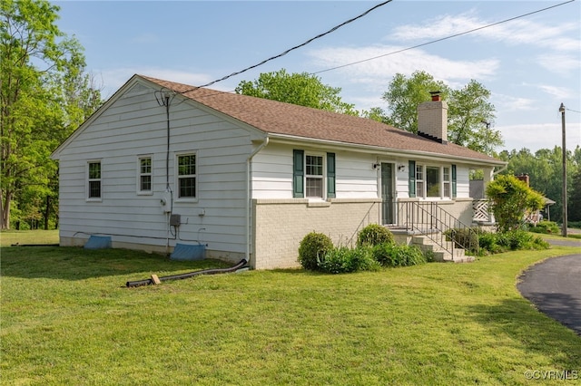149 Courthouse Ln, Bowling Green, VA 22427 - rear view of house with a chimney, a yard, and brick siding