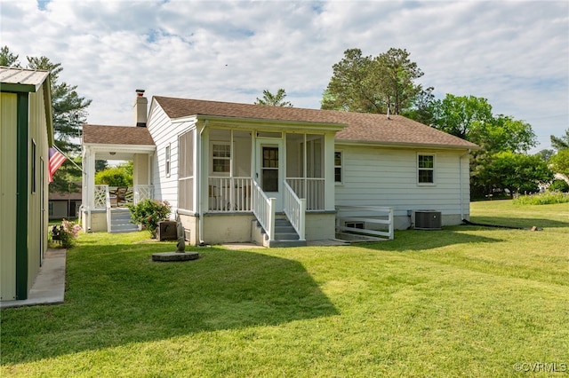 149 Courthouse Ln, Bowling Green, VA 22427 - rear view of house with a shingled roof, a lawn, central AC, and a chimney