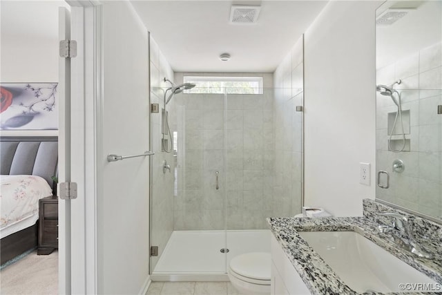 ensuite bathroom featuring vanity, connected bathroom, toilet, and a shower stall