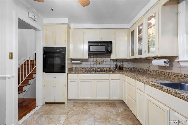 kitchen featuring tasteful backsplash, black appliances, ceiling fan, and glass insert cabinets