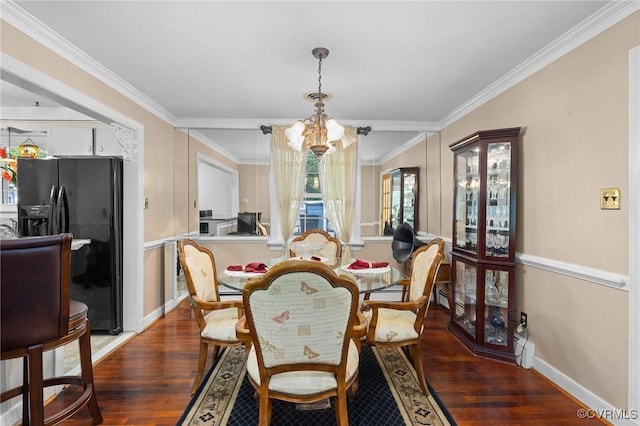 dining area with a chandelier, wood finished floors, and ornamental molding