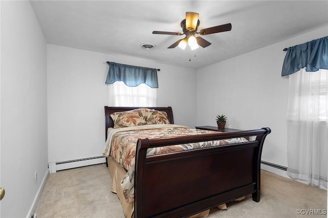 bedroom with a ceiling fan, visible vents, light carpet, baseboards, and baseboard heating