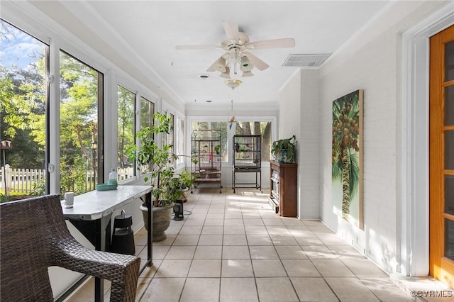sunroom / solarium with tile patterned floors and visible vents