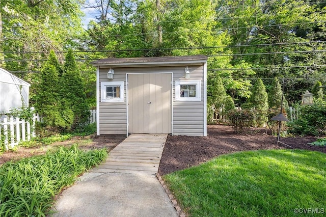 view of shed featuring fence