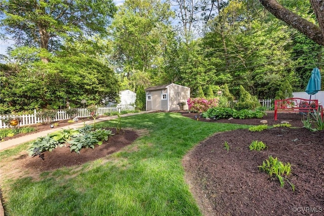 view of yard with fence, a storage shed, and an outdoor structure
