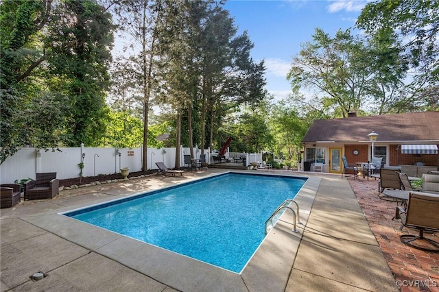 view of pool with a fenced in pool, a fenced backyard, and a patio area