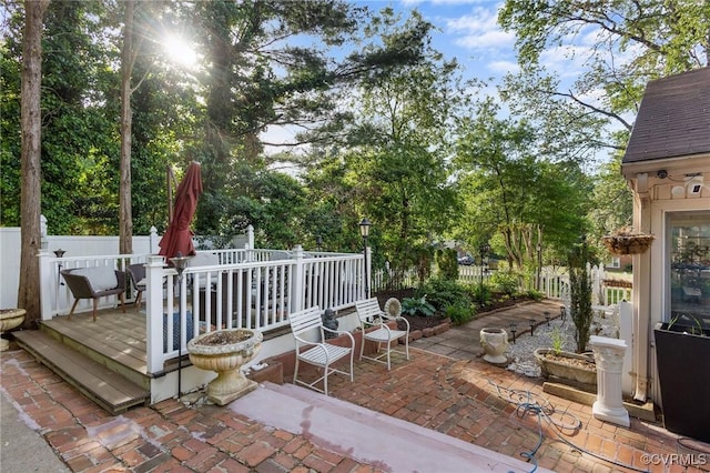 view of patio / terrace with a deck and a fenced backyard