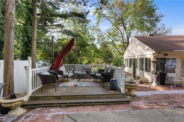 wooden deck featuring outdoor lounge area and fence