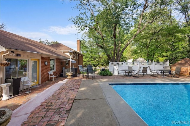 view of swimming pool with a patio, a fenced backyard, and a fenced in pool