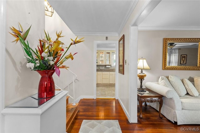 hallway with ornamental molding, dark wood-style floors, and baseboards