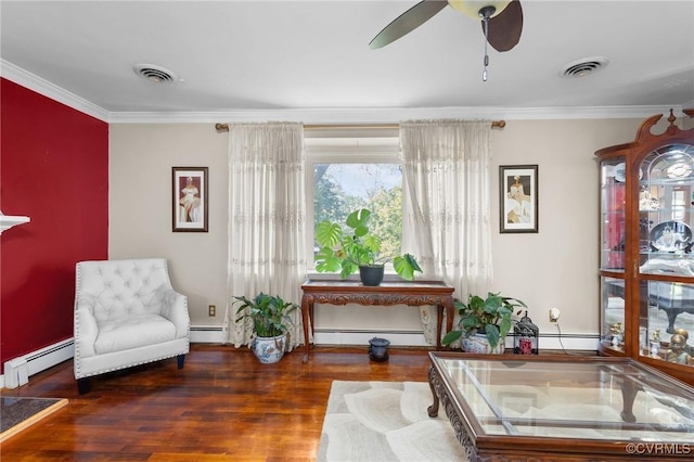 living area featuring baseboard heating, visible vents, ornamental molding, and wood finished floors