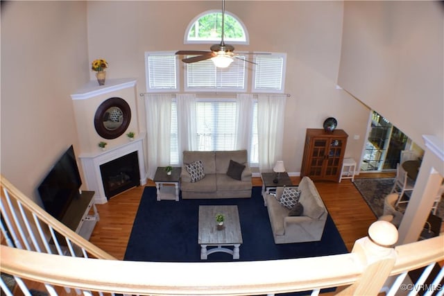 8313 Kalliope Ct, Chesterfield, VA 23838 - living room with a towering ceiling, a ceiling fan, wood finished floors, a fireplace, and baseboards