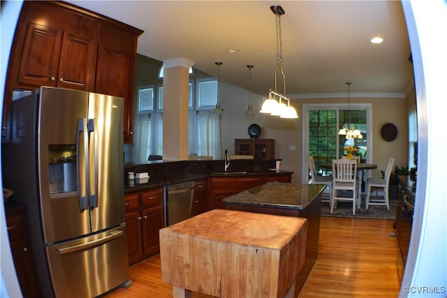 8313 Kalliope Ct, Chesterfield, VA 23838 - kitchen featuring appliances with stainless steel finishes, a kitchen island, ornamental molding, a sink, and light wood-style floors