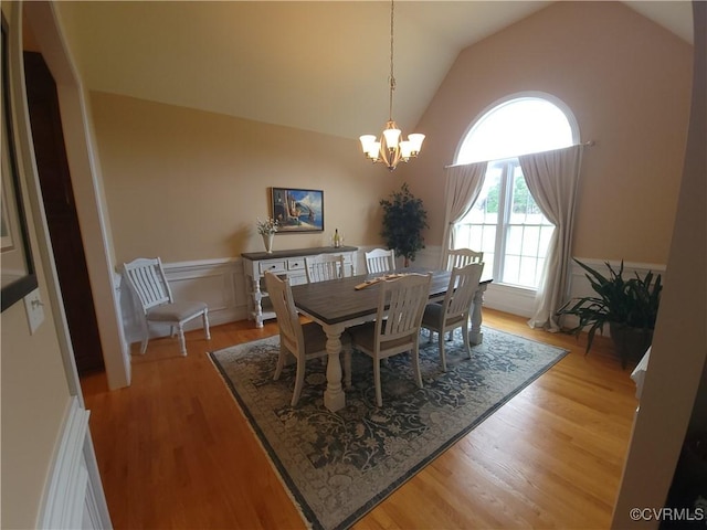 8313 Kalliope Ct, Chesterfield, VA 23838 - dining space with a chandelier, light wood-type flooring, vaulted ceiling, and wainscoting
