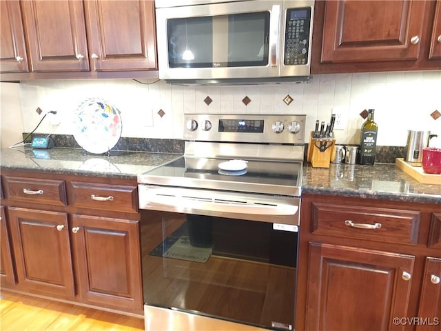 8313 Kalliope Ct, Chesterfield, VA 23838 - kitchen with appliances with stainless steel finishes, backsplash, light wood-style floors, and dark stone counters