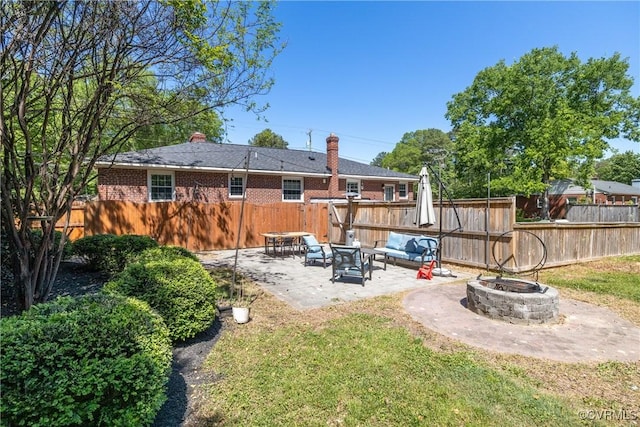 back of property with fence, a patio, and a fire pit