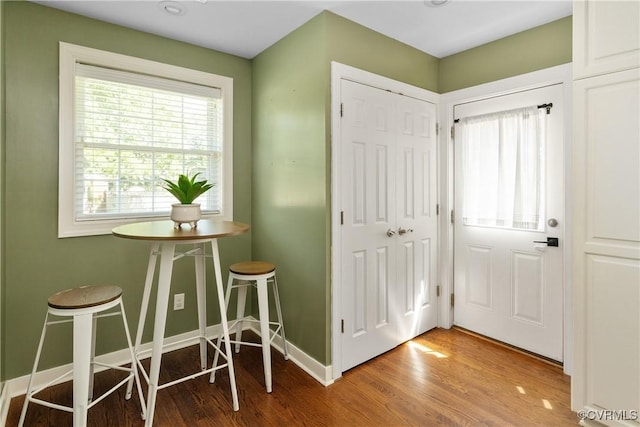 entrance foyer featuring baseboards and wood finished floors