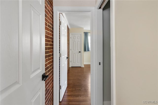 corridor featuring baseboards and dark wood-style floors