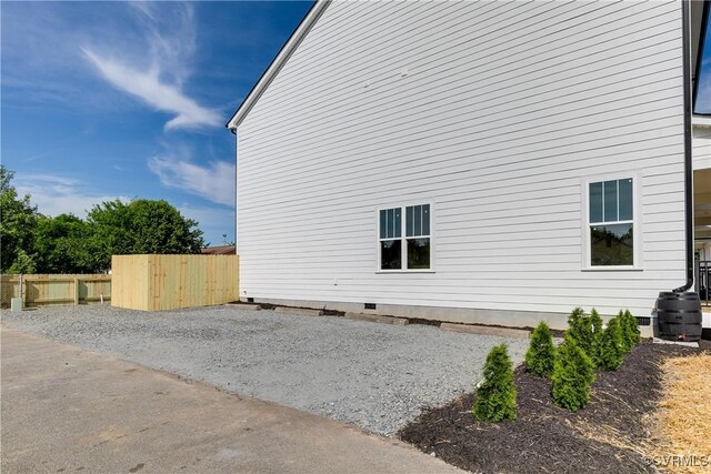 view of property exterior with crawl space and fence