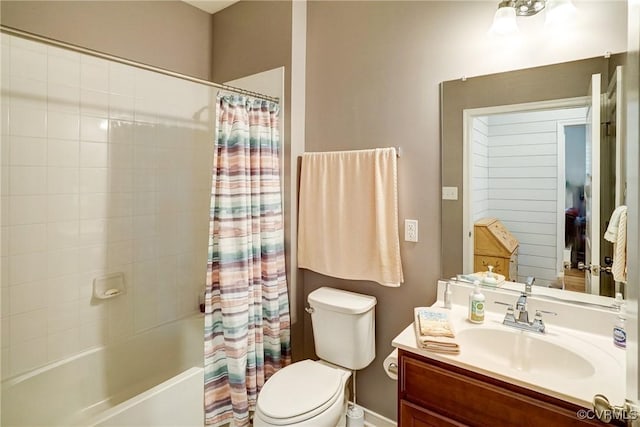 full bathroom with vanity, baseboards, shower / bath combo, and toilet