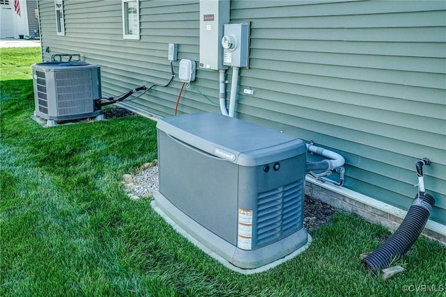 details with electric meter, central AC unit, and a power unit