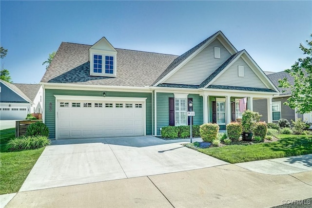 craftsman inspired home with a shingled roof, a garage, a porch, a front yard, and driveway