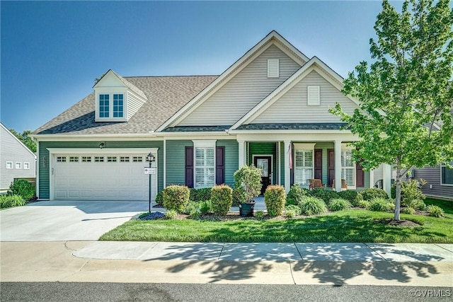 craftsman house with a garage, a porch, a shingled roof, and driveway