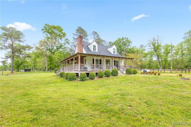 rear view of property featuring a lawn, fence, covered porch, and a chimney