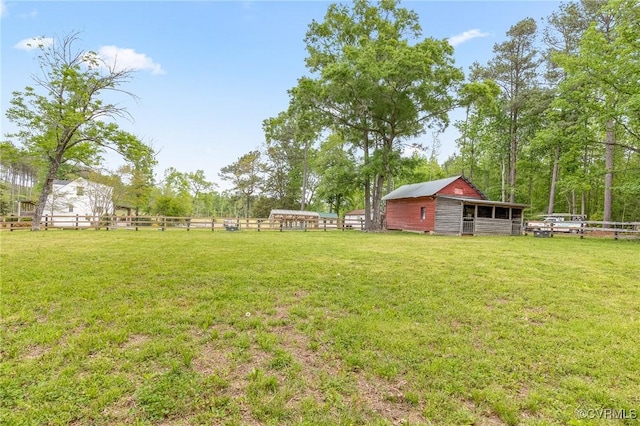 view of yard featuring an outdoor structure and an exterior structure