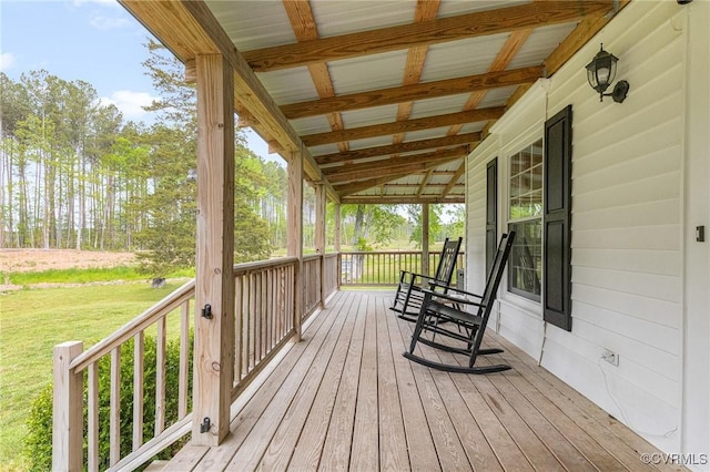 deck featuring a lawn and a porch