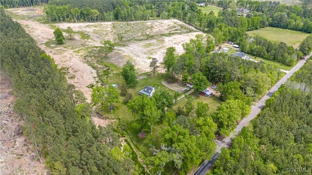 drone / aerial view featuring a wooded view