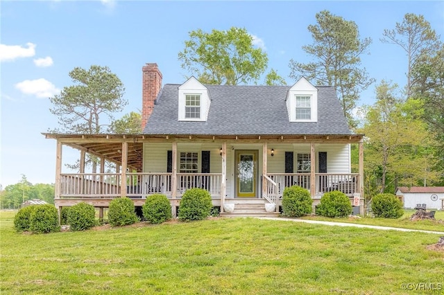 view of front of property with a shingled roof and a front lawn