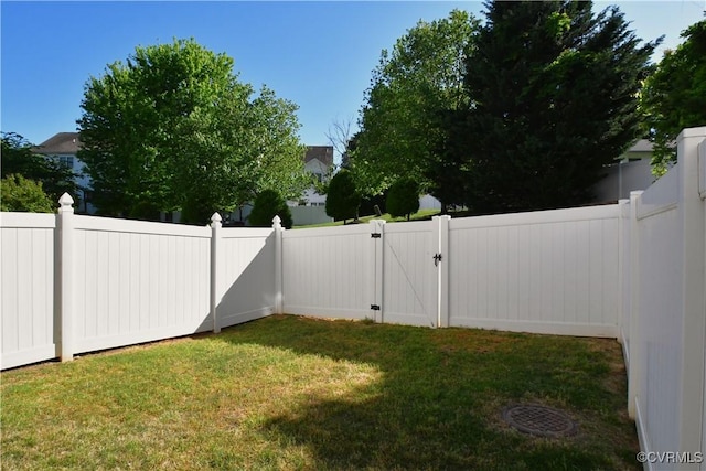 view of yard featuring a gate and a fenced backyard