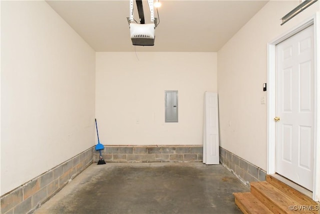 garage with a garage door opener and electric panel