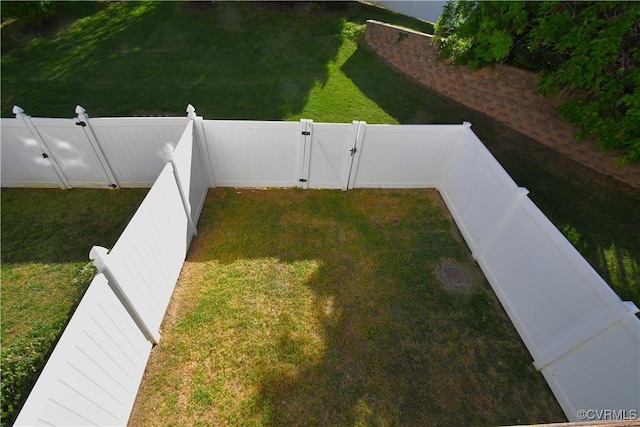 view of yard with a gate and a fenced backyard
