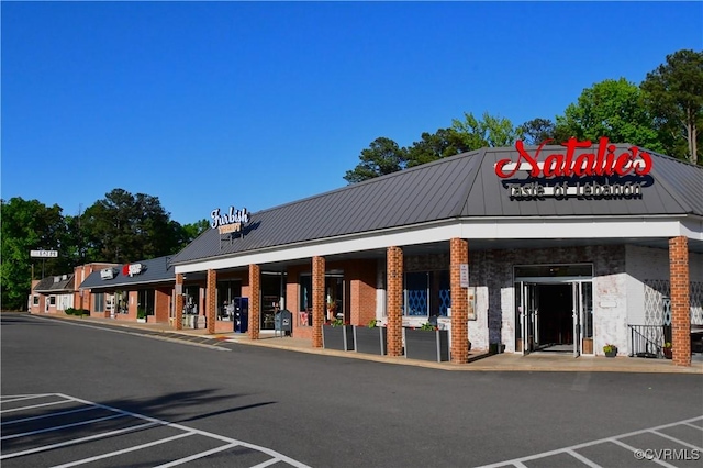 view of building exterior with uncovered parking