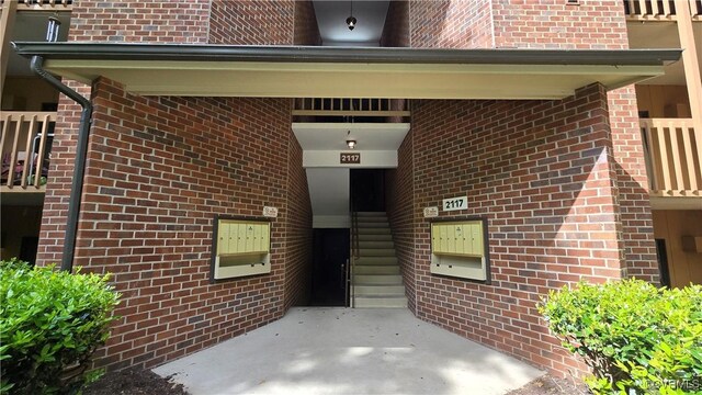 entrance to property featuring brick siding